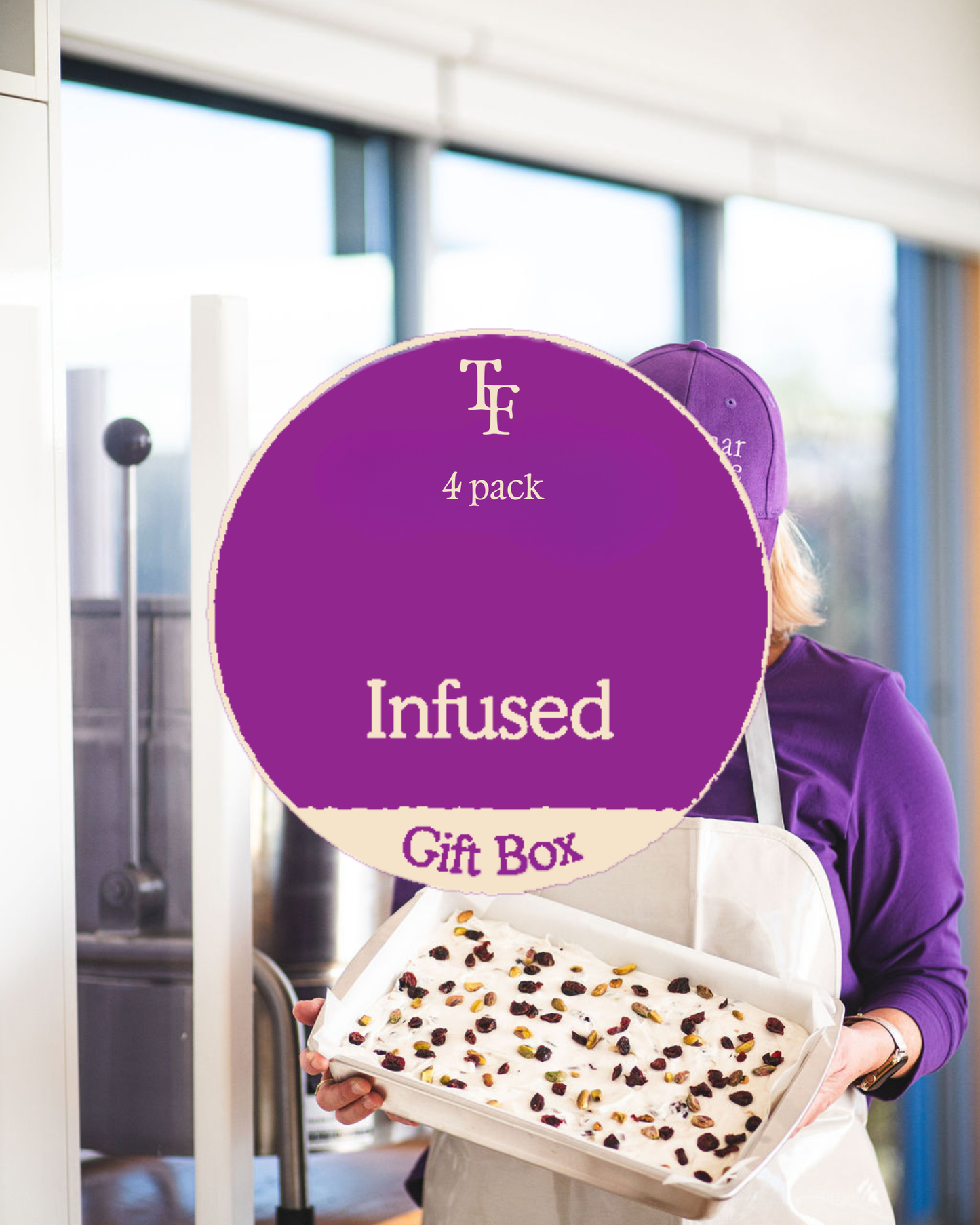 Person in a purple shirt and apron holding a tray of white chocolate rocky road topped with pistachios and dried fruit, overlaid with a purple ‘Infused Gift Box – 4 pack’ badge.