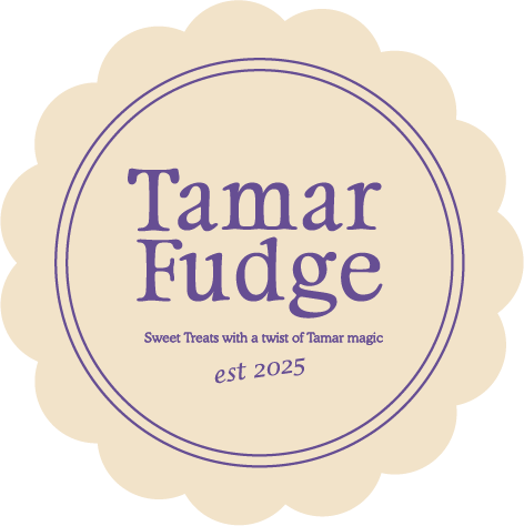 Cream-coloured Tamar Fudge badge with purple text and scalloped border.